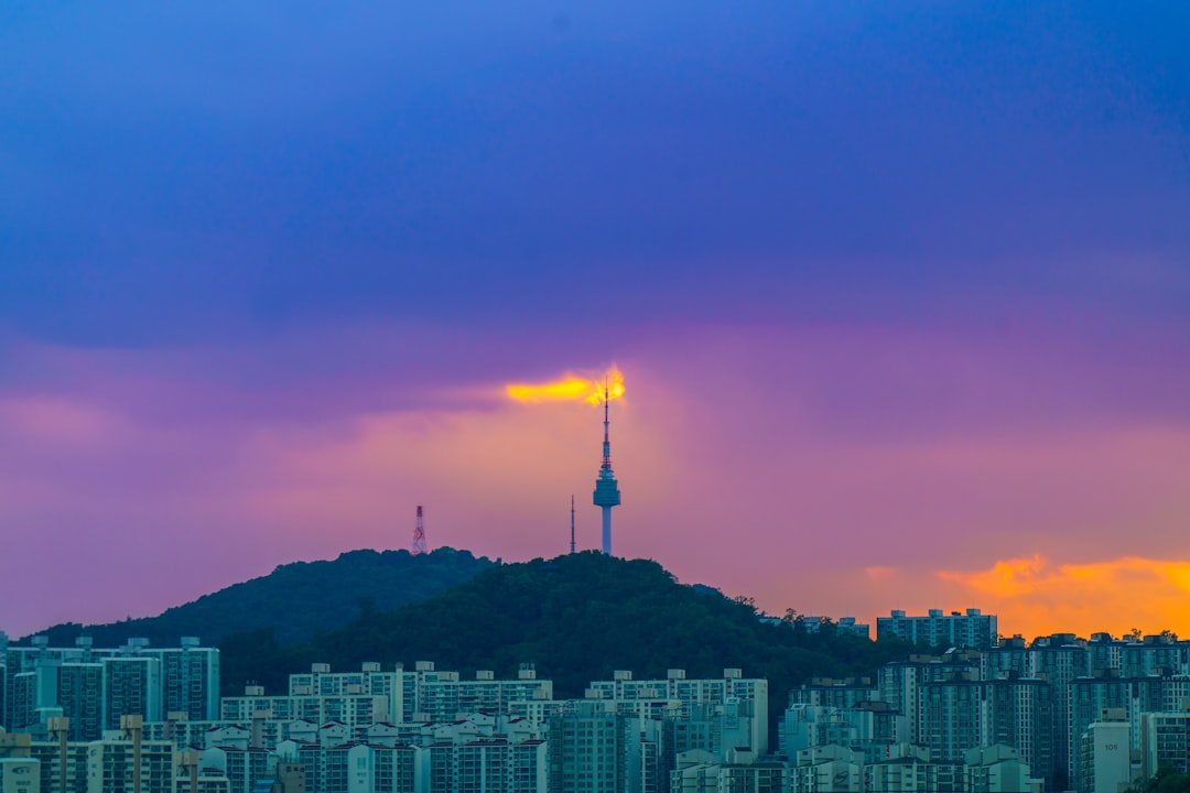 A tower stands against a colorful sunset sky.