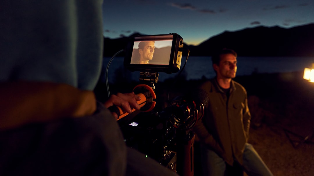 a man standing next to a man holding a camera