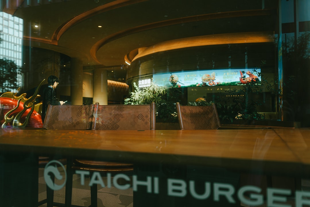 Restaurant interior with a long wooden table and chairs.