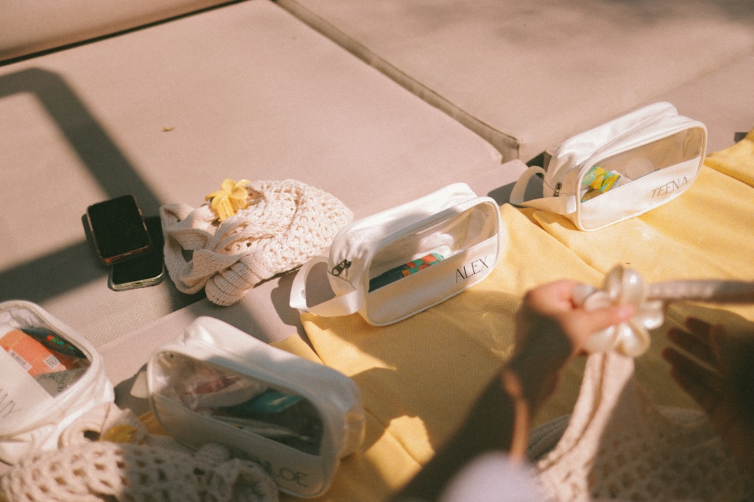 Several pouches and a phone on a yellow surface.