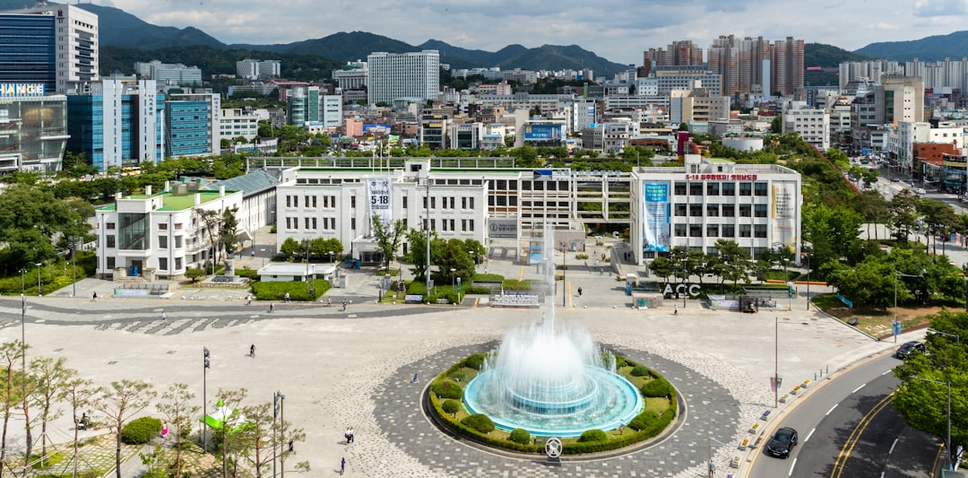 people walking on park near fountain during daytime