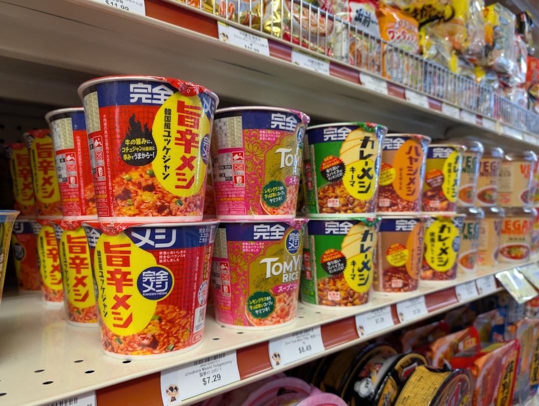 Shelves stocked with various instant ramen cups.