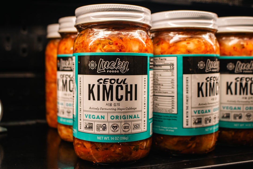 Jars of vegan seoul kimchi displayed on a shelf.