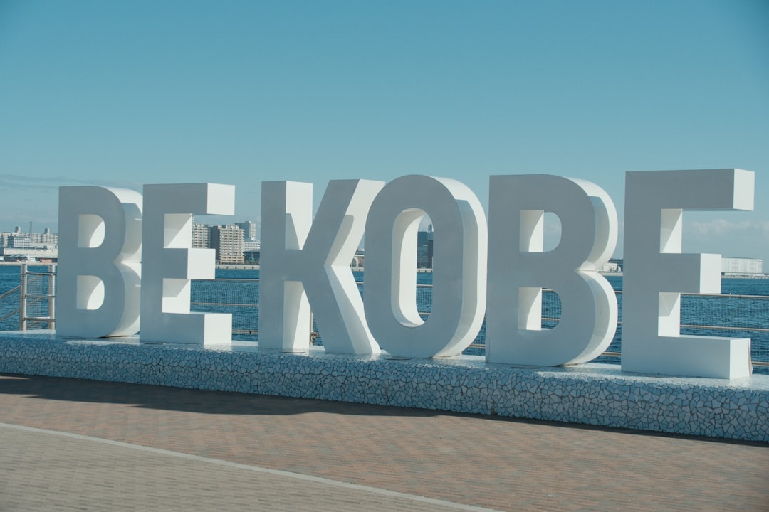 Large white be kobe sign by the water