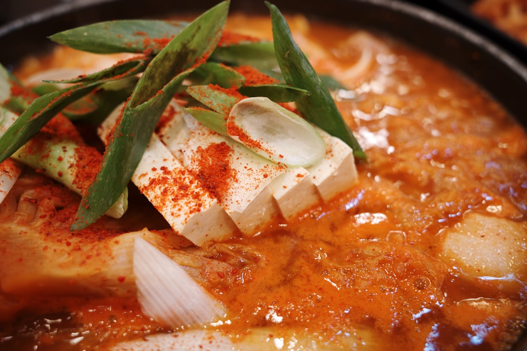Close-up of spicy korean stew with tofu and scallions