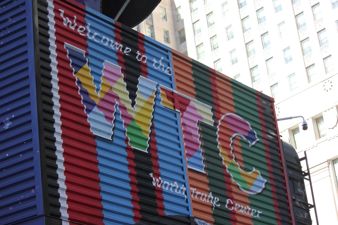 A large colorful container sitting on the side of a building