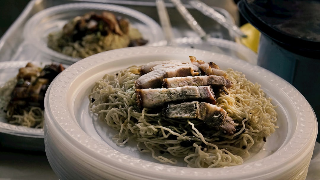 Noodles topped with sliced roasted pork