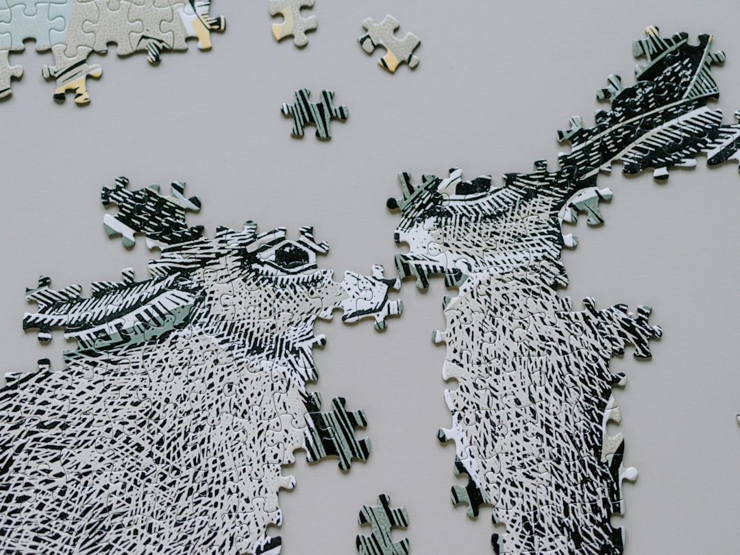 Two unfinished donkey puzzle pieces face each other.