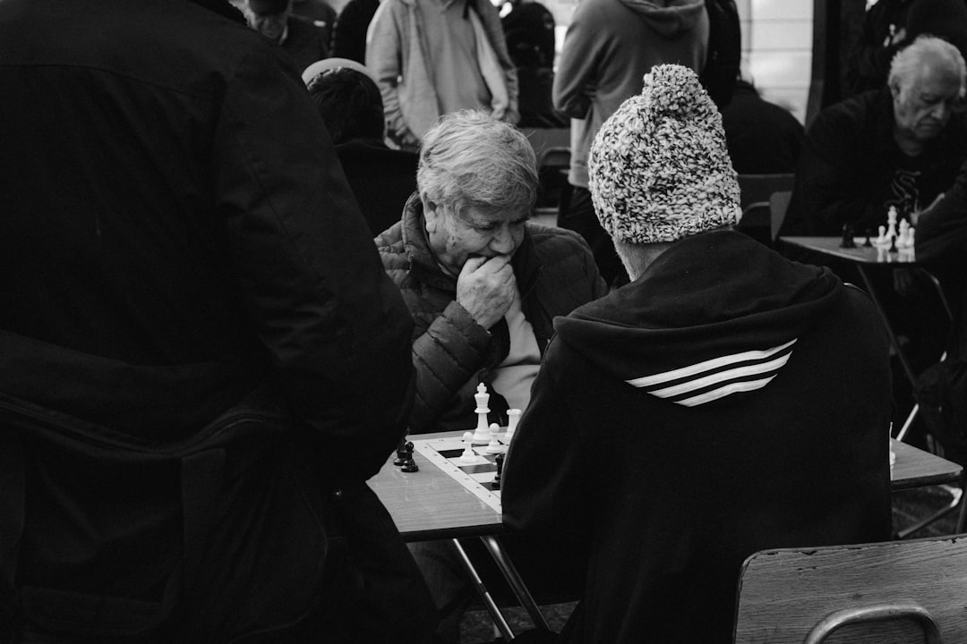 Two people playing chess at a table
