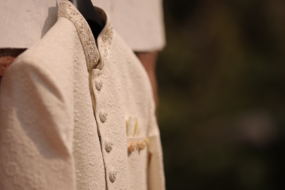A close up of a person wearing a white coat