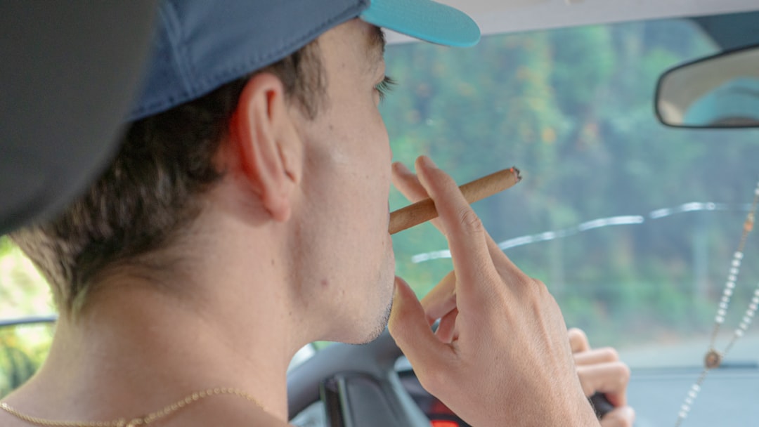 A man smoking a cigarette in a car