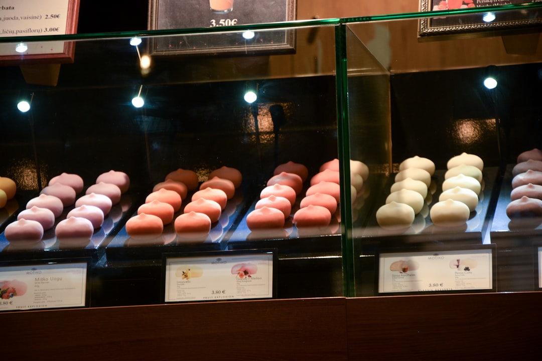 a display case filled with lots of different colored donuts