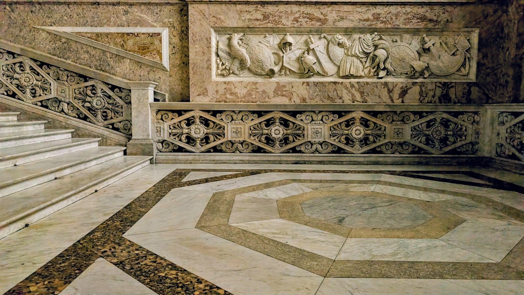 Marble staircase and ornate wall relief in grand building