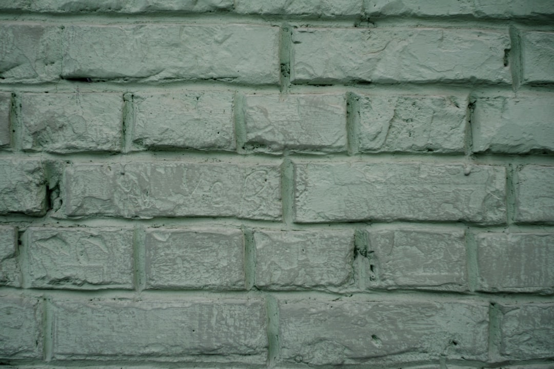 A light green painted brick wall texture