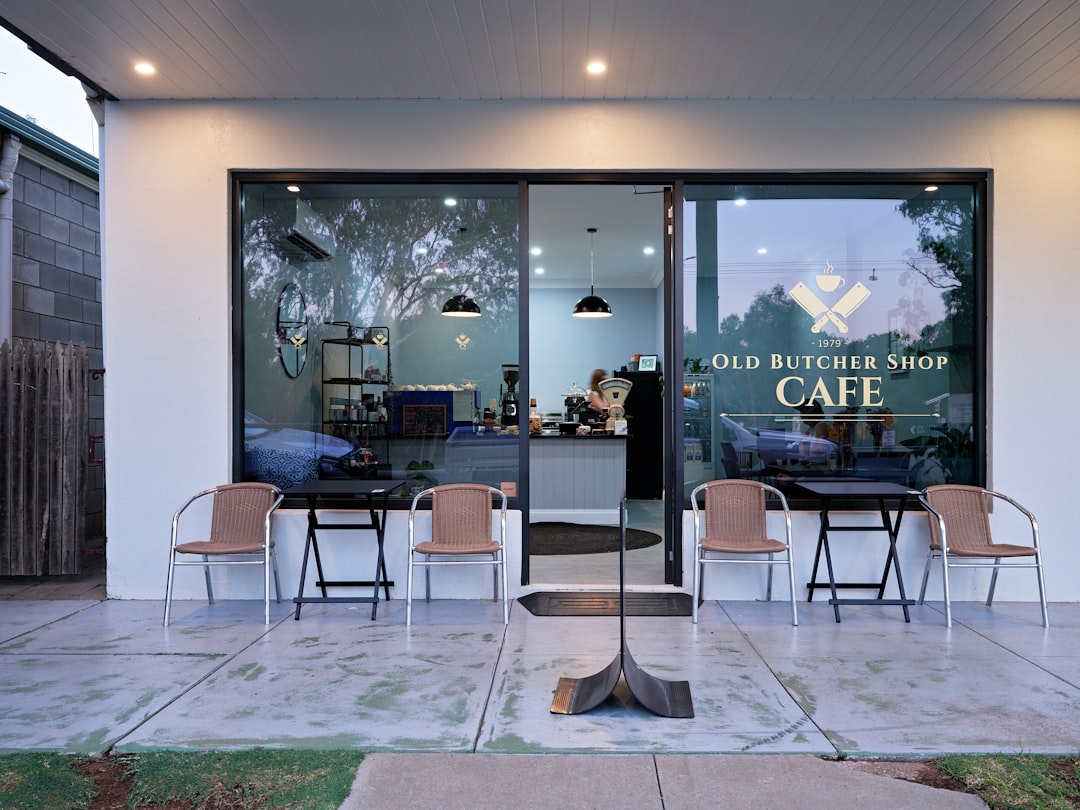 The outside of a coffee shop with tables and chairs