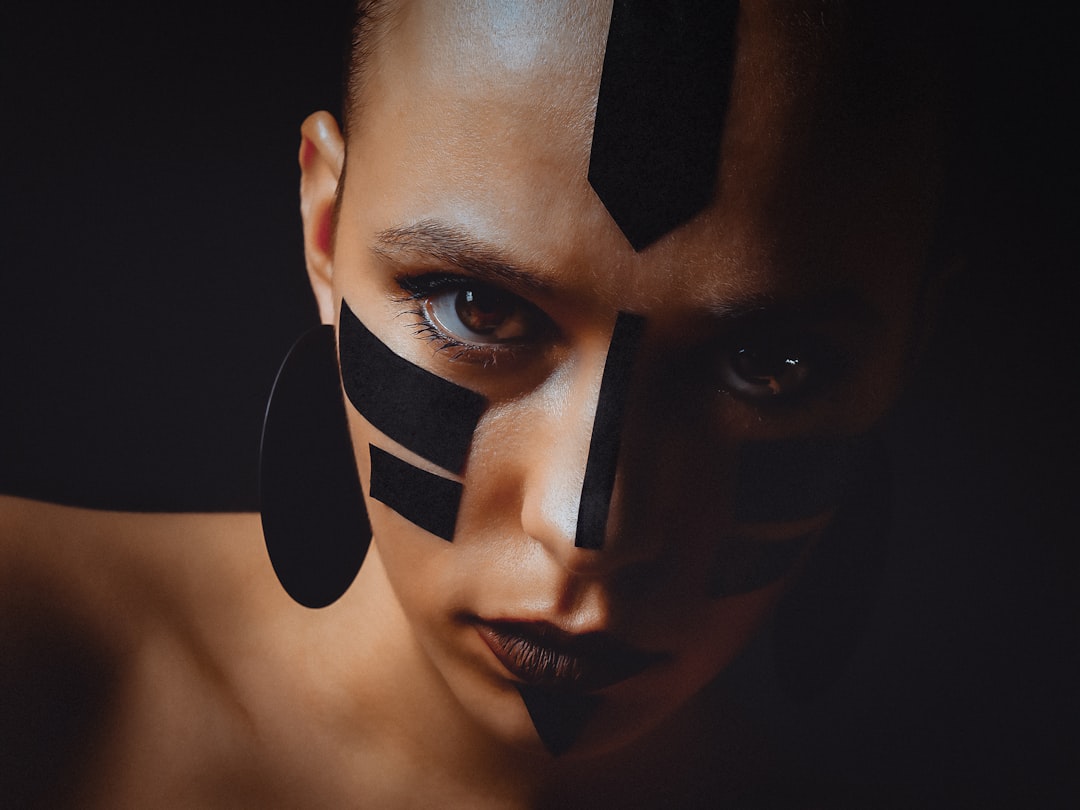 Woman with abstract black face paint and body paint