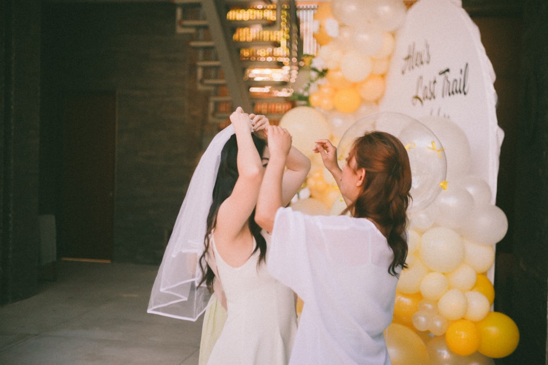 Bride getting veil adjusted by a friend