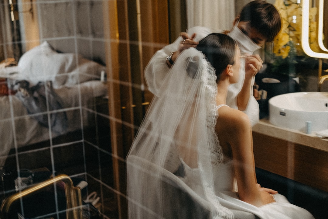 Bride getting hair styled before wedding ceremony