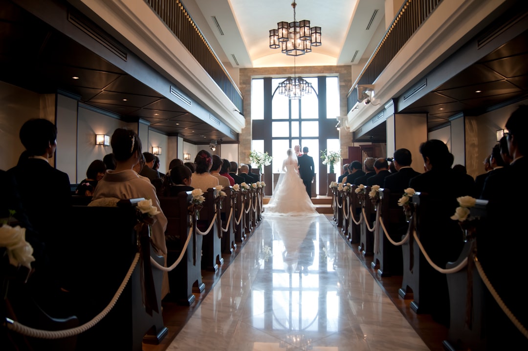 a bride and groom are walking down the aisle
