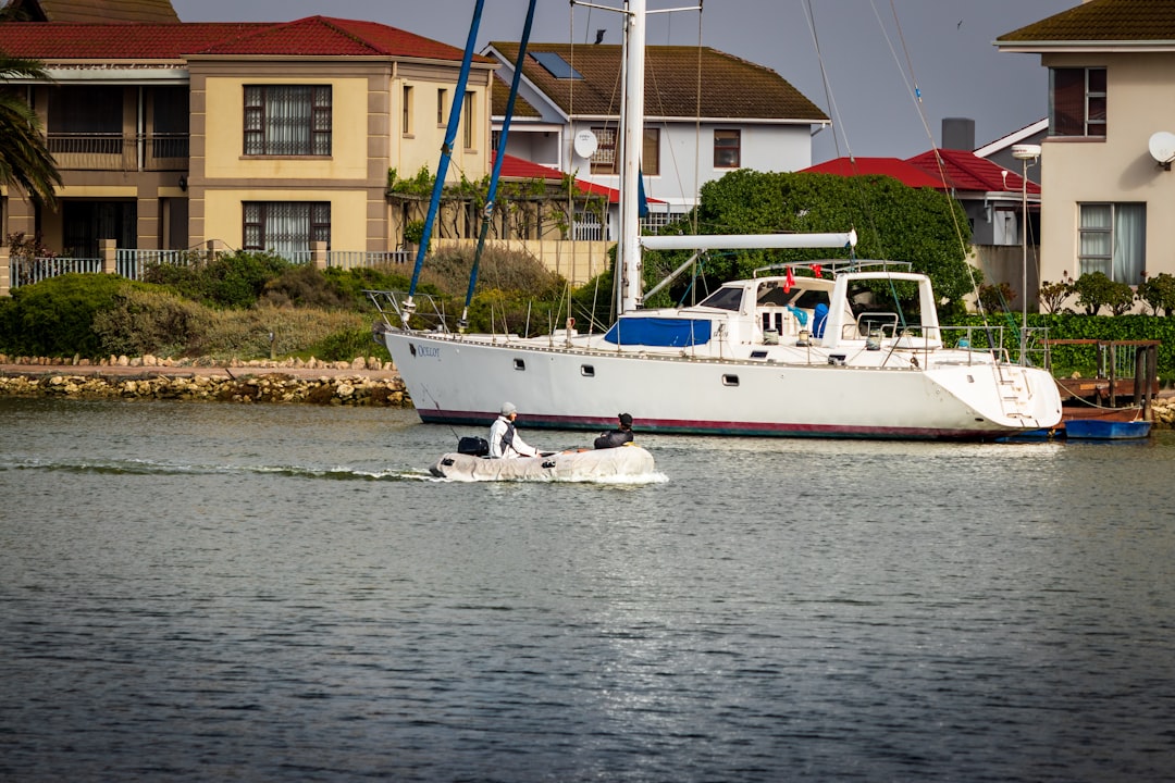 white and blue boat on sea during daytime