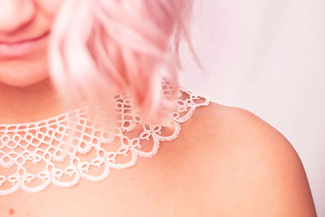 Woman with pink hair wearing a white lace collar