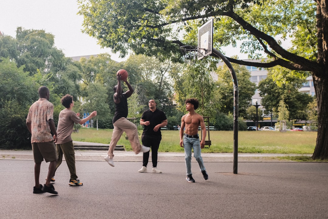 A group of young men playing a game of basketball