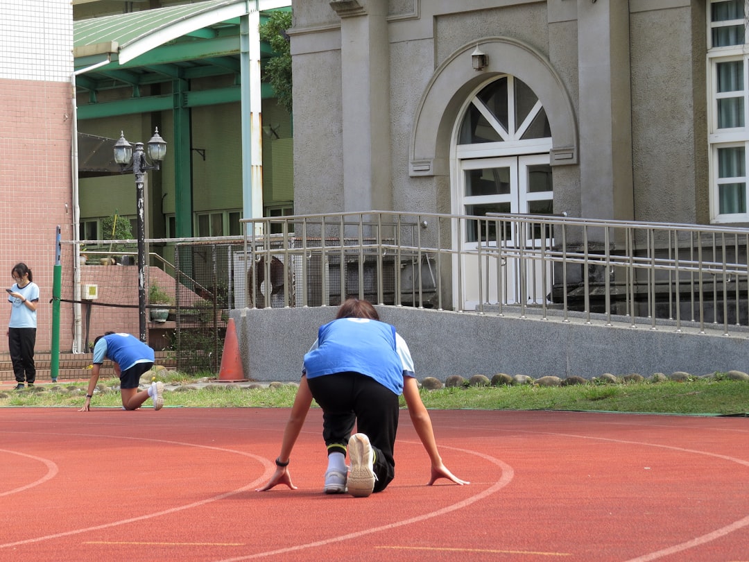 Athletes on a running track preparing to start