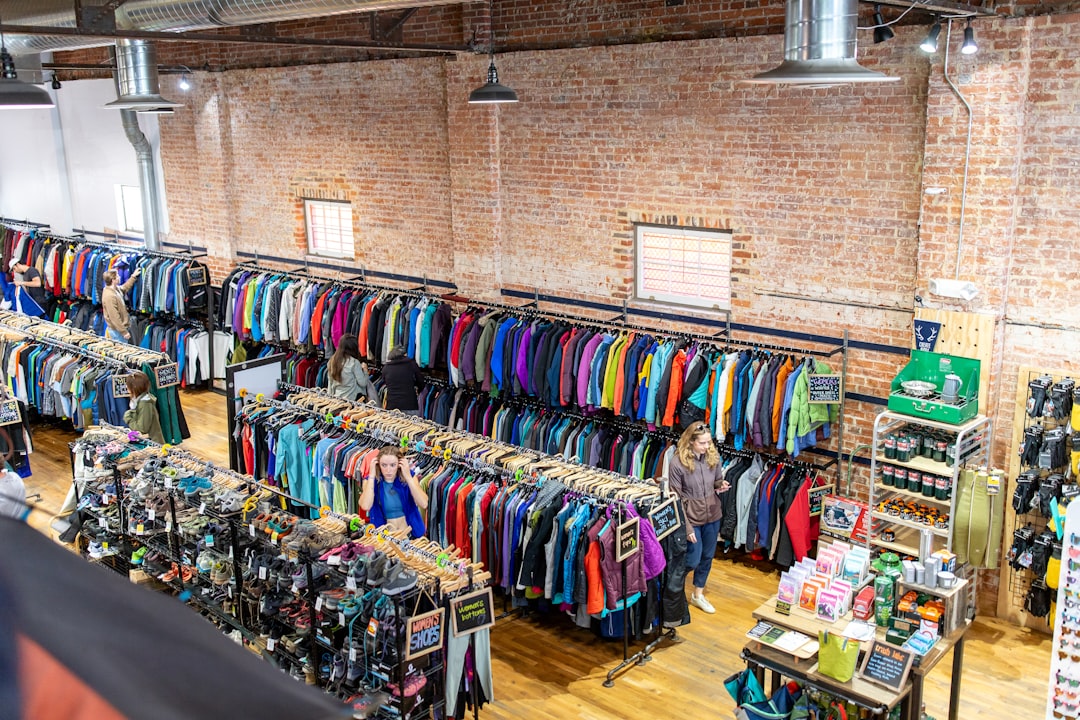 Retail store interior with racks of colorful clothing.
