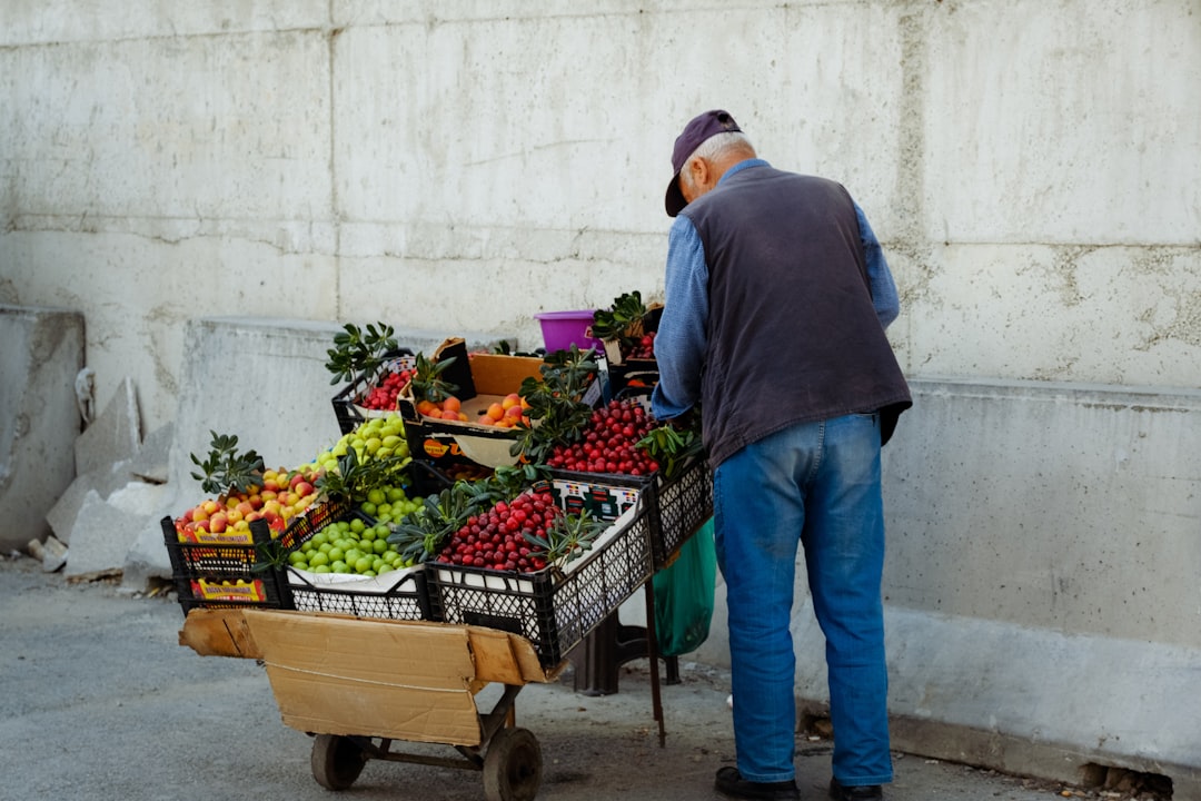 a person pushing a cart full of fruits
