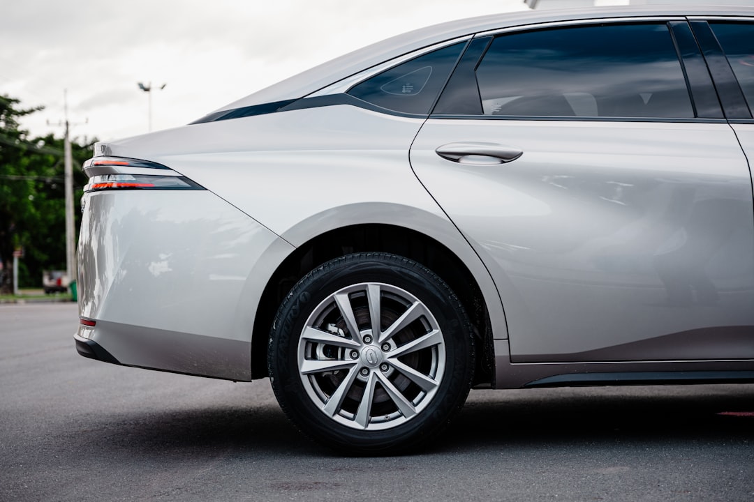 Silver sedan car parked on asphalt