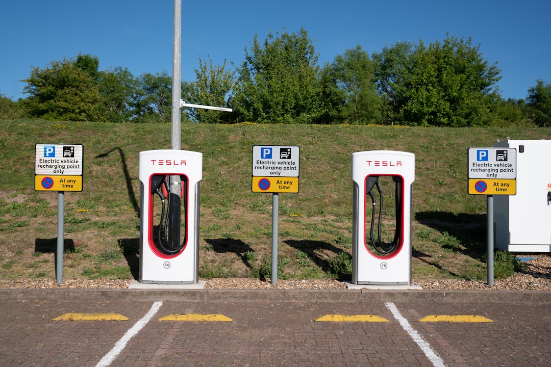 Tesla electric car charging stations on a sunny day.