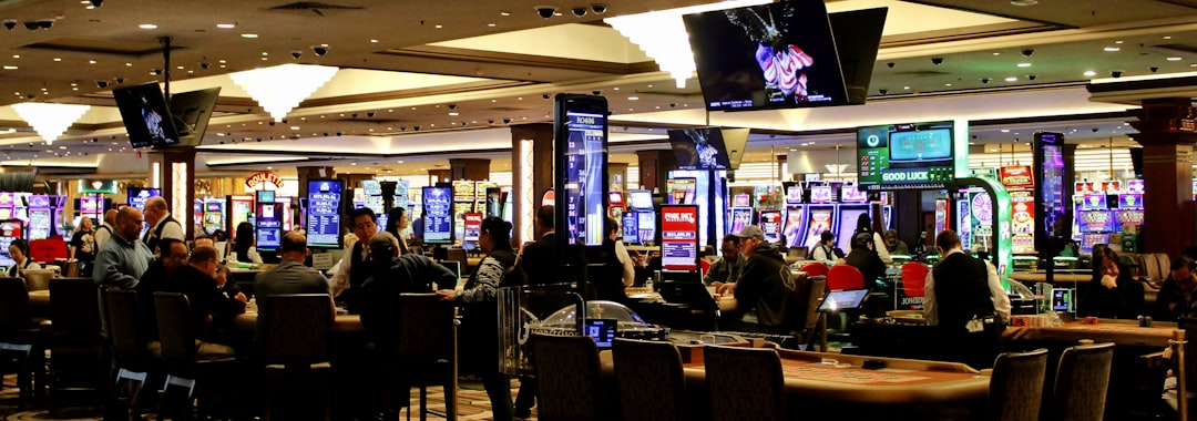 People playing slot machines in a brightly lit casino.