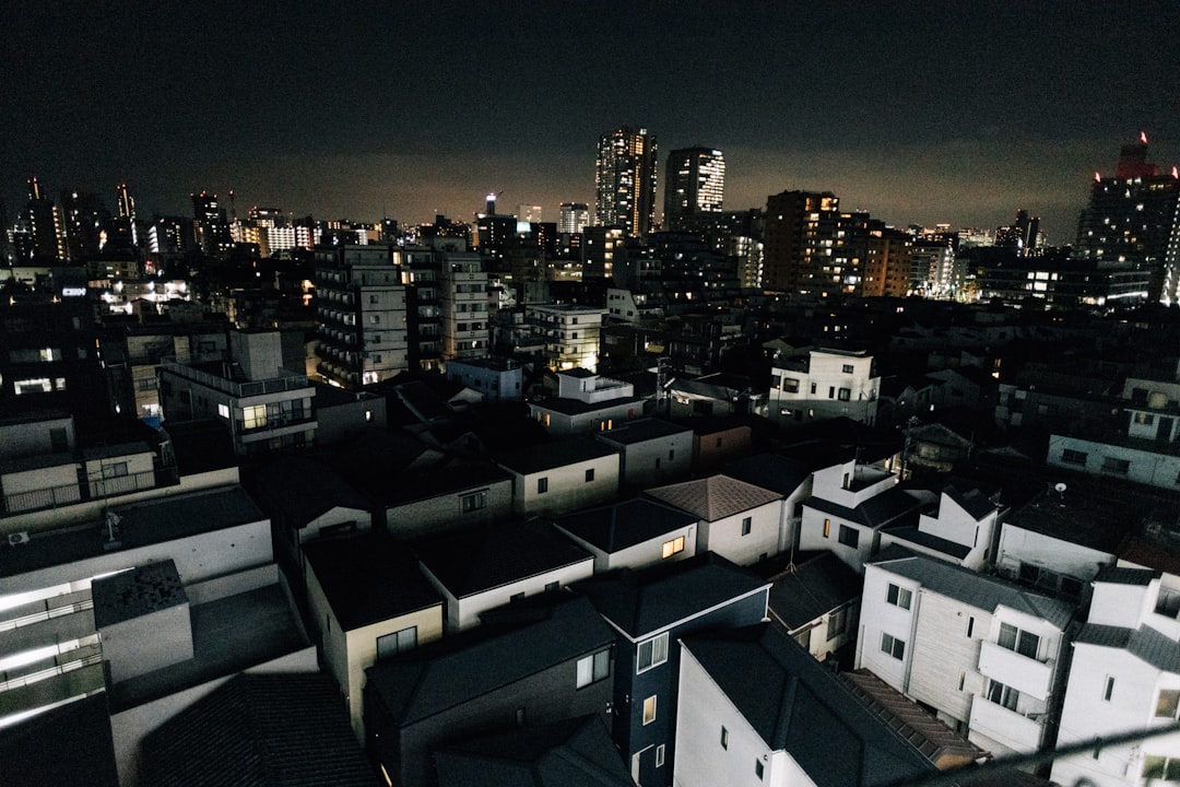 A sprawling cityscape illuminated at night with many buildings.