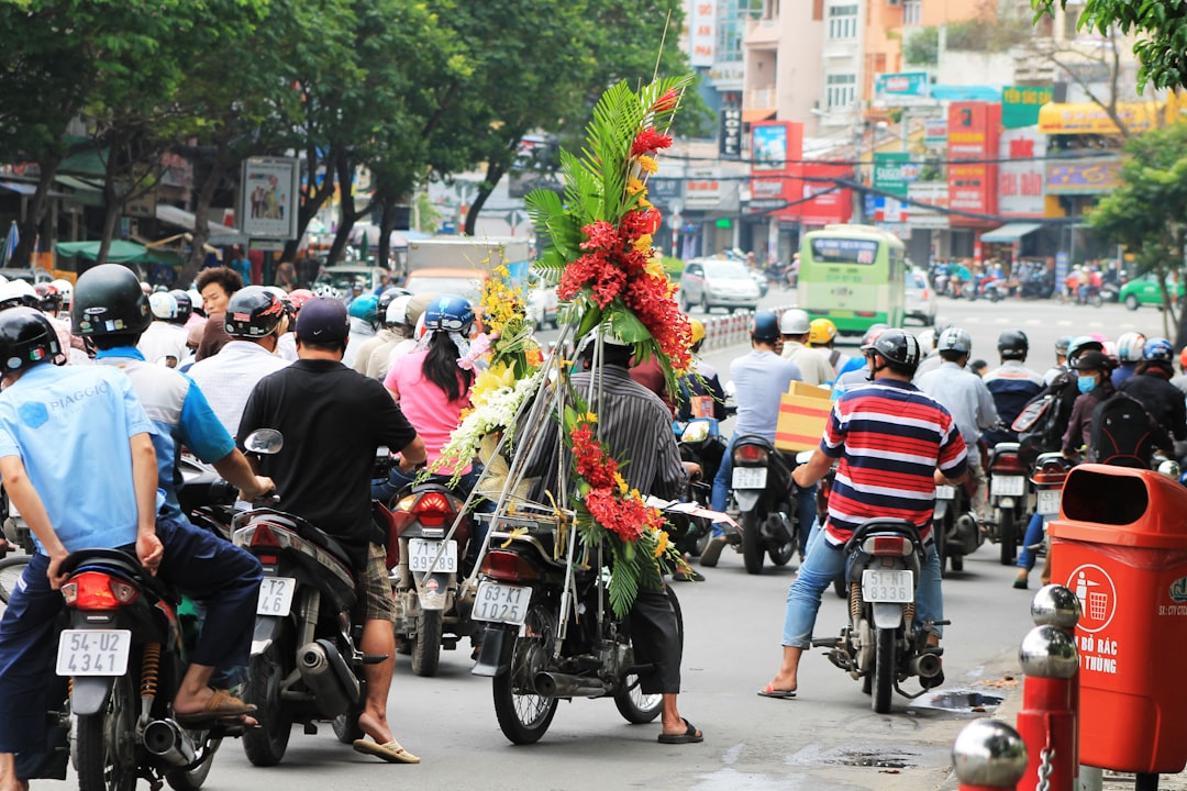 a group of people riding motorcycles down a street