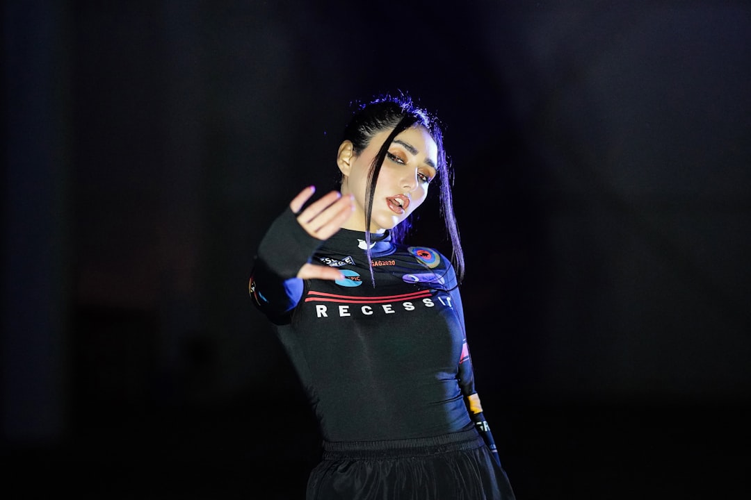 a woman in a black dress holding a microphone