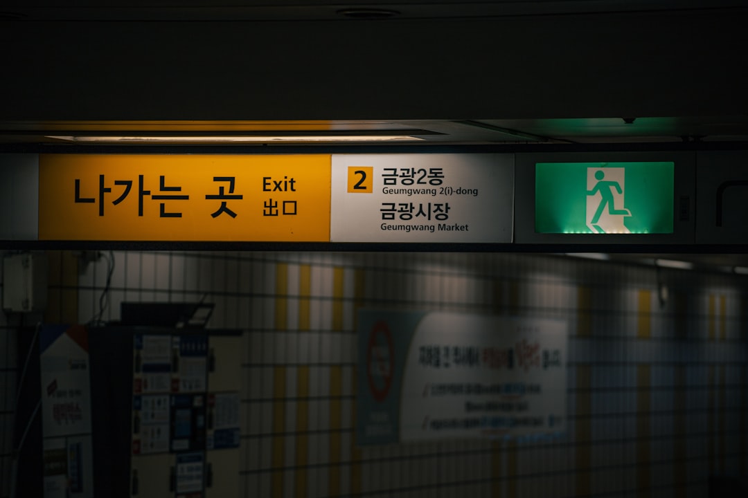 a yellow and green sign in a subway station