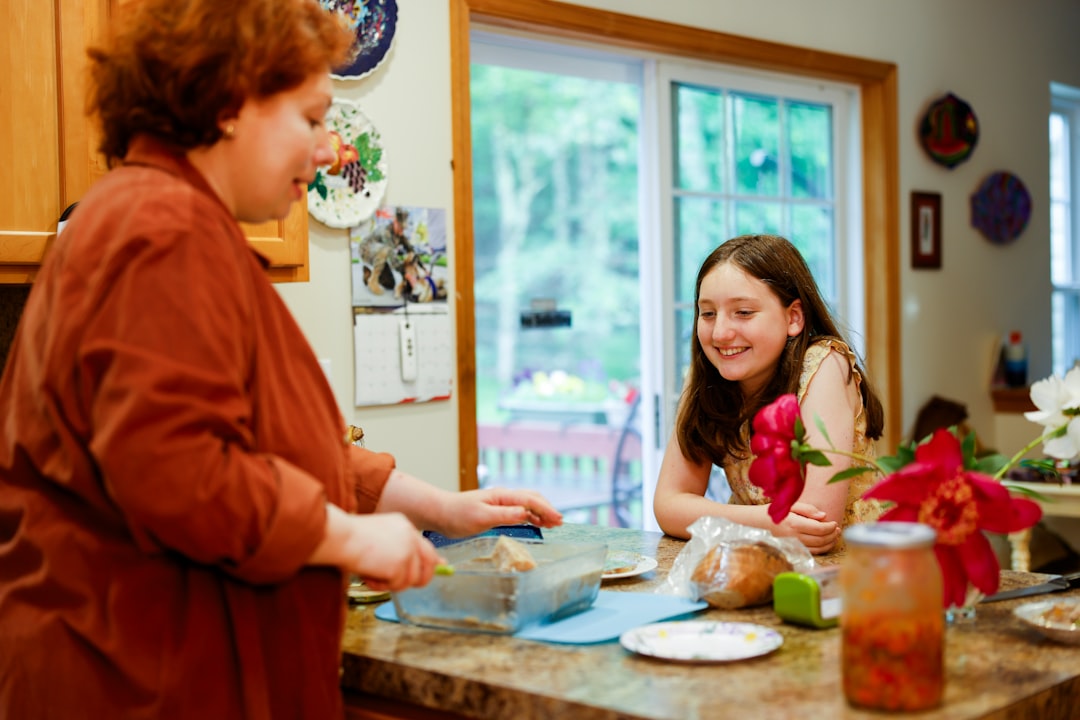 Woman preparing food with a girl watching