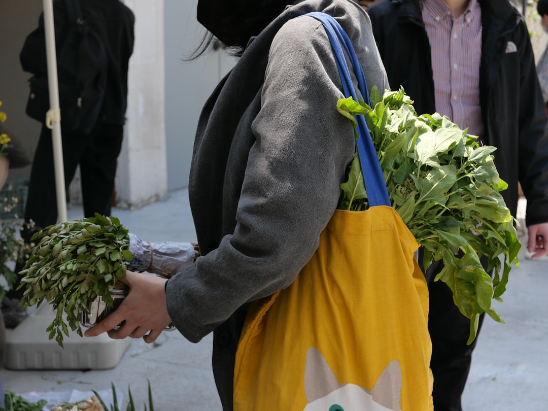A person carrying a bag with plants in it