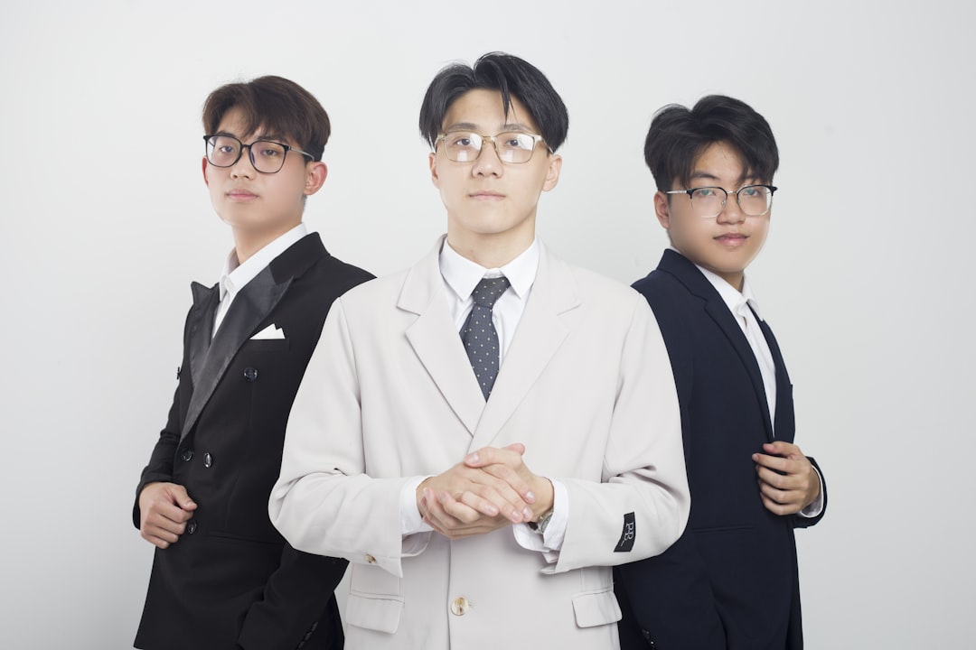 a group of three men standing next to each other