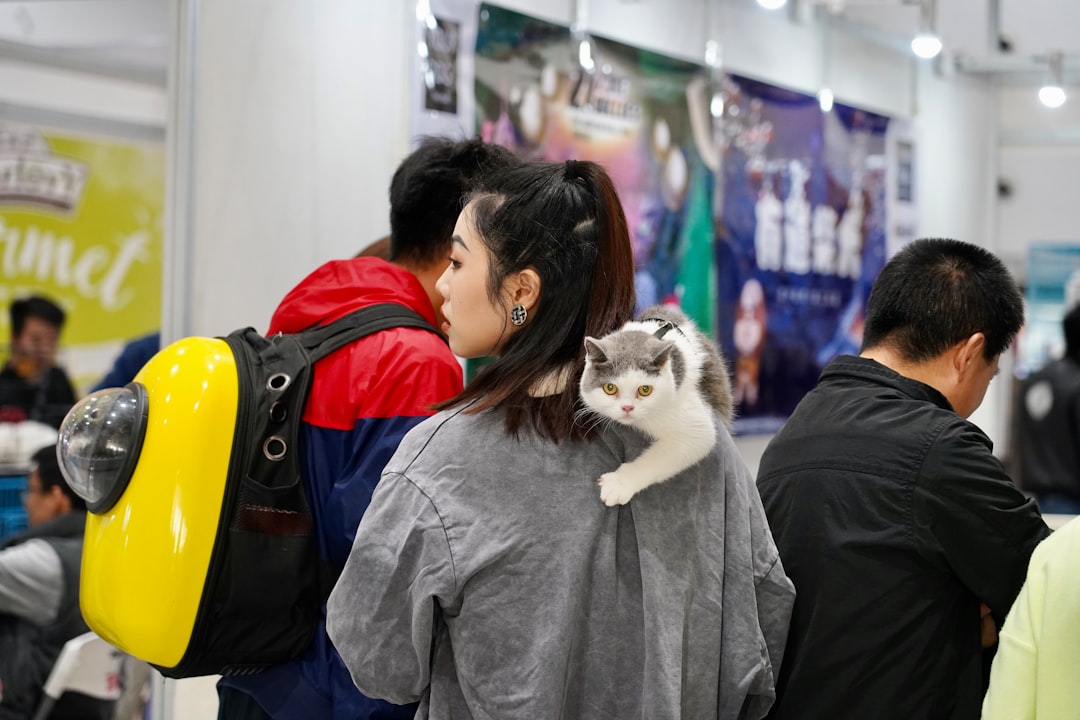 a woman with a cat on her shoulder