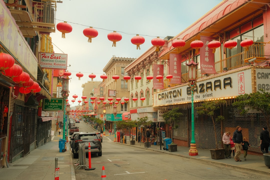 Red lanterns hang over a street in chinatown.