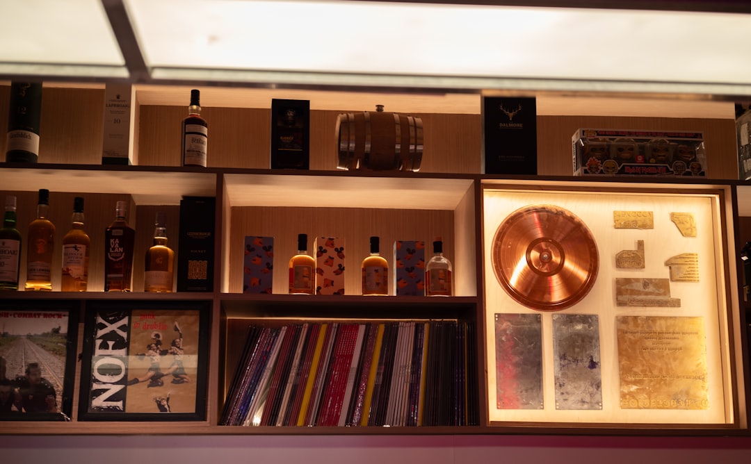 Shelves display bottles, records, and framed music award.