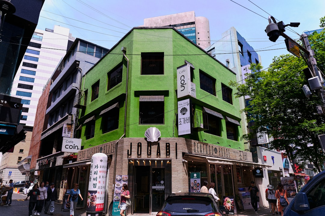 a green building on a city street corner