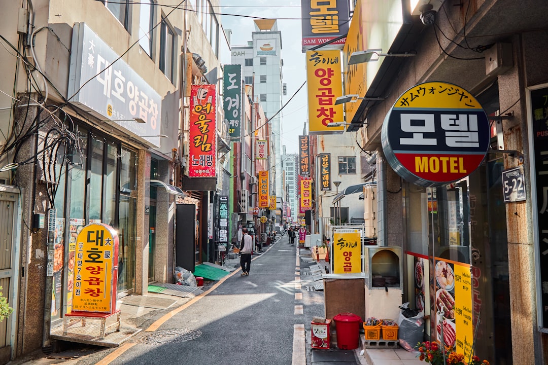Narrow street lined with shops and signs