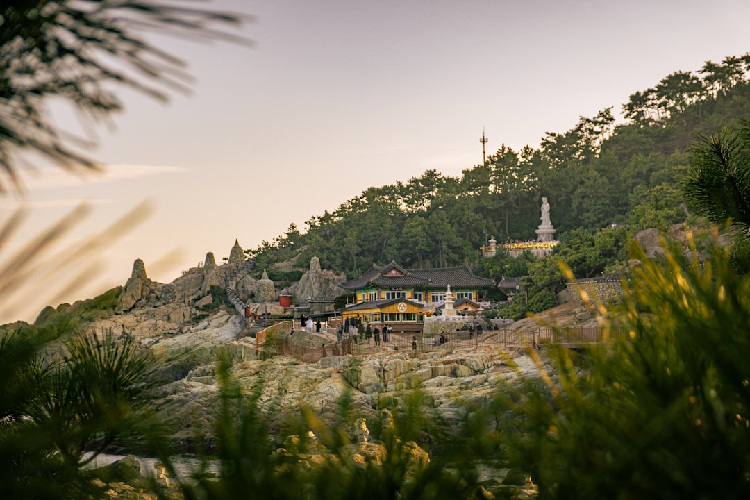 Scenic view of a traditional building on a rocky hillside.