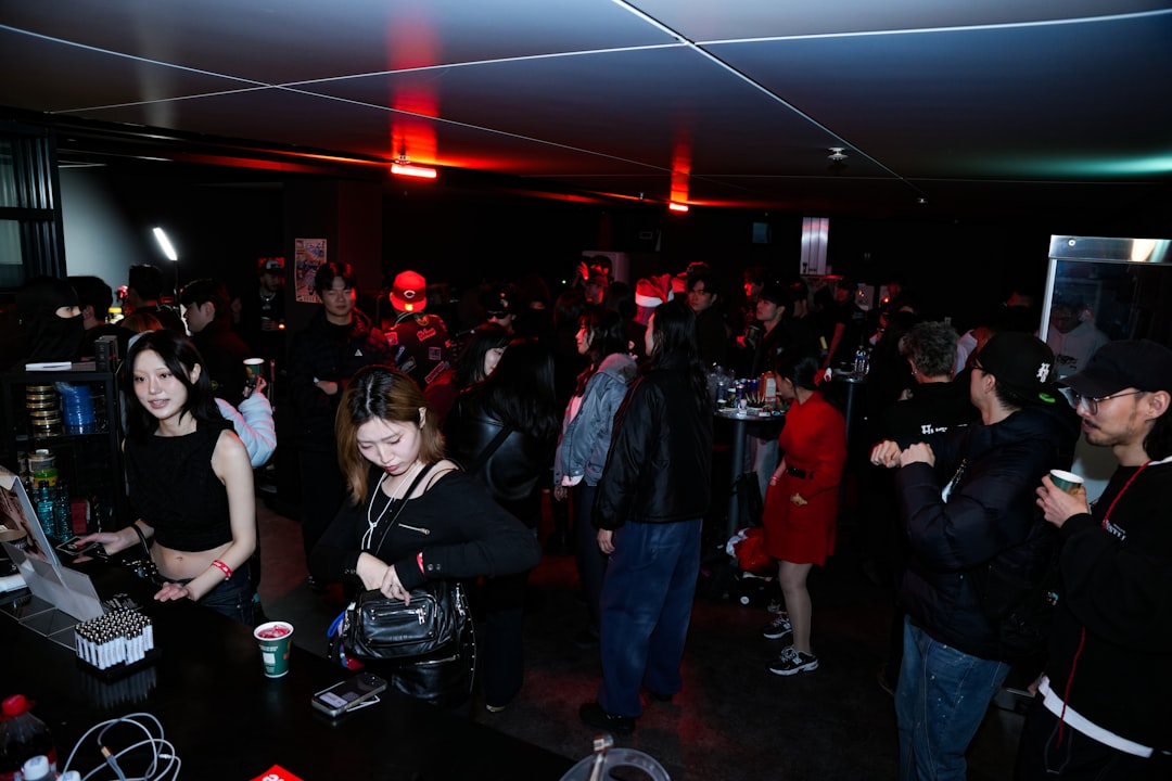 A crowd of people gathered in a dimly lit room.