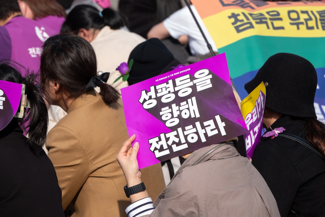 A group of people holding signs and wearing masks