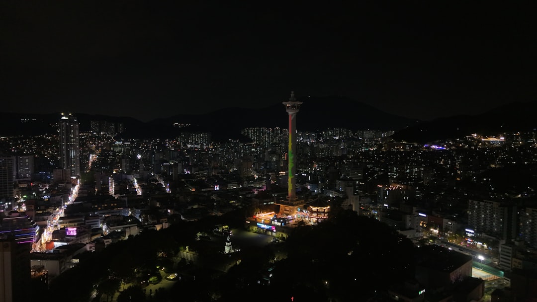 Cityscape with a tall tower at night