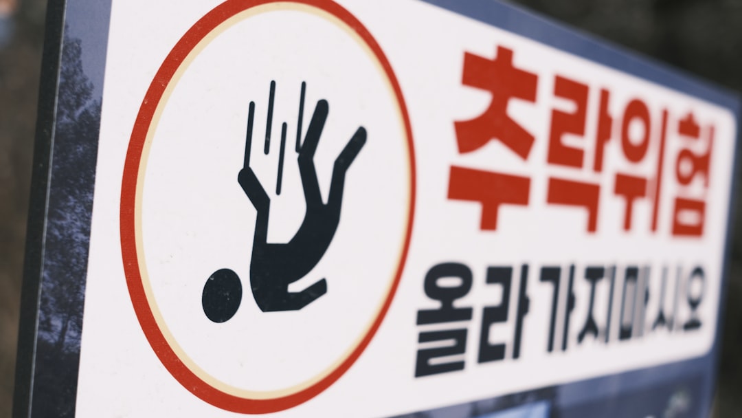 Warning sign for slipping hazard with falling person icon.