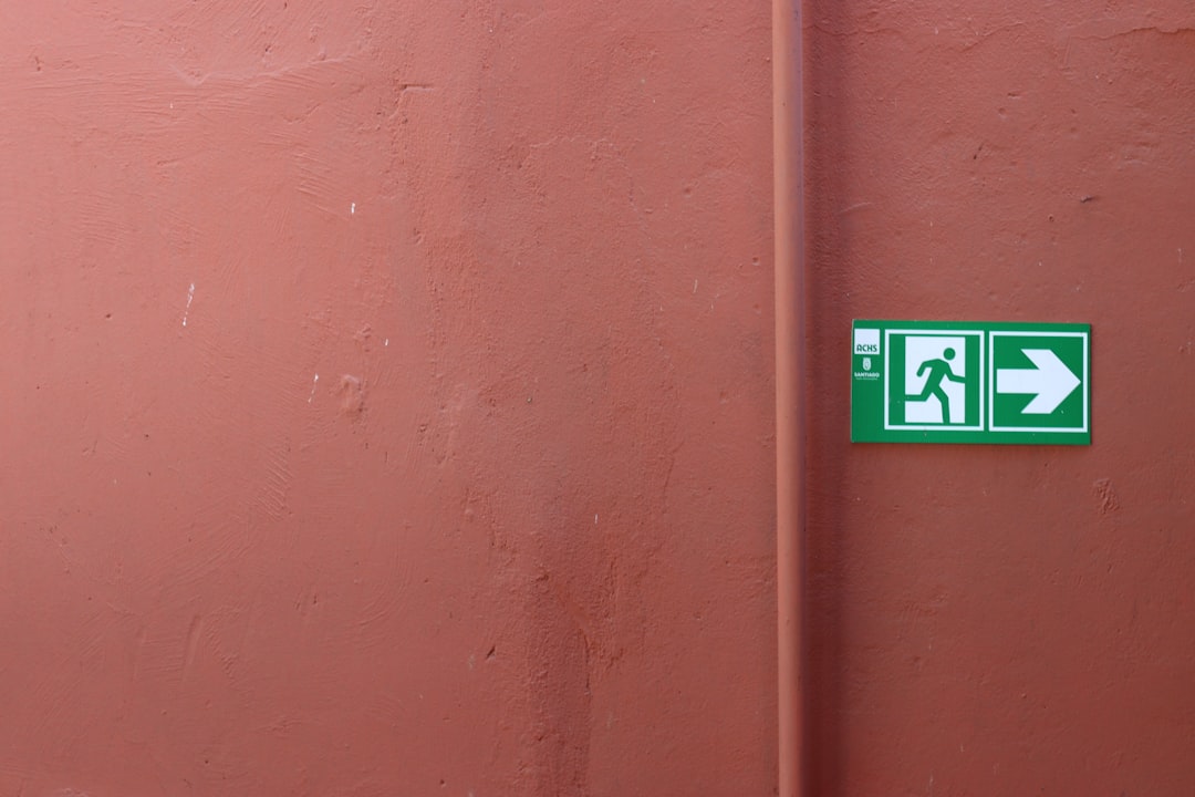 Emergency exit sign pointing to the right.
